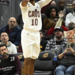 
              Cleveland Cavaliers guard Darius Garland reacts after being hit in the face during the second half of an NBA basketball game against the Sacramento Kings, Friday, Dec. 9, 2022, in Cleveland. (AP Photo/Nick Cammett)
            