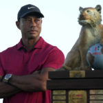 
              Tiger Woods stands next to the trophy after Norway,'s Viktor Hovland won the Hero World Challenge PGA Tour at the Albany Golf Club in New Providence, Bahamas, Sunday, Dec. 4, 2022. (AP Photo/Fernando Llano)
            