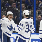 
              Toronto Maple Leafs right wing William Nylander (88) celebrates his goal against the Tampa Bay Lightning with center Auston Matthews (34) and defenseman Mark Giordano (55) during the second period of an NHL hockey game Saturday, Dec. 3, 2022, in Tampa, Fla. (AP Photo/Chris O'Meara)
            