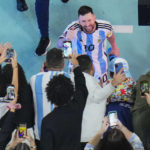 
              FILE - Argentina's Lionel Messi greets cheering fans after his team's 3-0 win in the World Cup semifinal soccer match between Argentina and Croatia at the Lusail Stadium in Lusail, Qatar, Wednesday, Dec. 14, 2022. (AP Photo/Hassan Ammar, File)
            