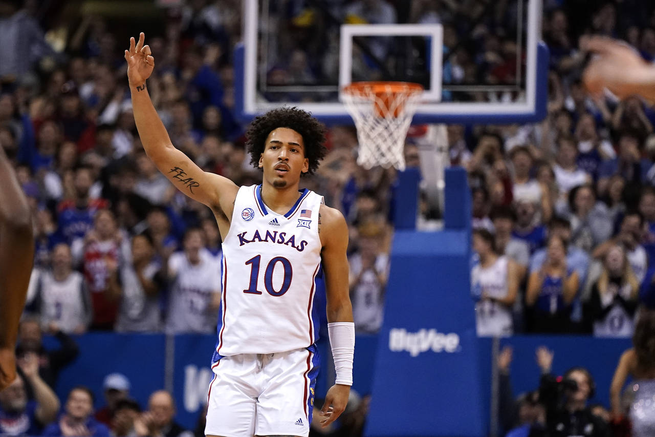 Kansas forward Jalen Wilson celebrates after making a basket during the first half of an NCAA colle...