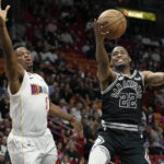 
              San Antonio Spurs guard Malaki Branham (22) goes for the ball as Miami Heat guard Kyle Lowry (7) defends during the first half of an NBA basketball game, Saturday, Dec. 10, 2022, in Miami. (AP Photo/Lynne Sladky)
            