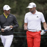 
              FILE - Rory McIlroy, left, of Northern Ireland, and Sergio Garcia, of Spain, walk up the 15th fairway during a practice round for the Masters golf tournament April 5, 2017, in Augusta, Ga. McIlroy, in a lengthy interview in the Sunday Independent in Ireland, says his close friendship with Garcia ended over a testy text exchange at the U.S. Open. (AP Photo/Matt Slocum, File)
            