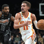 
              Atlanta Hawks guard Trae Young, right, drives against Brooklyn Nets guard Kyrie Irving during the first half of an NBA basketball game Friday, Dec. 9, 2022, in New York. (AP Photo/Mary Altaffer)
            