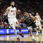 
              San Antonio Spurs guard Tre Jones (33) drives to the basket as Miami Heat forward Caleb Martin (16) defends during the first half of an NBA basketball game, Saturday, Dec. 10, 2022, in Miami. (AP Photo/Lynne Sladky)
            