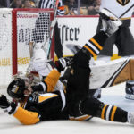 
              Pittsburgh Penguins' Jeff Carter, front, collides with Vegas Golden Knights goaltender Logan Thompson, rear, during the second period of an NHL hockey game in Pittsburgh, Thursday, Dec. 1, 2022. (AP Photo/Gene J. Puskar)
            