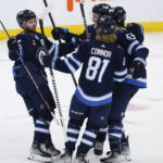 
              Winnipeg Jets' Josh Morrissey (44), Neal Pionk (4), Kyle Connor (81) and Mark Scheifele (55) celebrate after Scheifele's goal against the Vancouver Canucks during second-period NHL hockey game action in Winnipeg, Manitoba, Thursday, Dec. 29, 2022. (John Woods/The Canadian Press via AP)
            