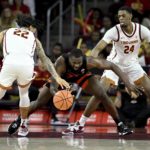 
              Oregon State forward Rodrigue Andela, center, regains possession with Southern California guard Tre White, left, and forward Joshua Morgan defending during the second half of an NCAA college basketball game in Los Angeles, Sunday, Dec. 4, 2022. (AP Photo/Alex Gallardo)
            