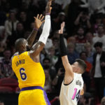
              Los Angeles Lakers forward LeBron James (6) shoots as Miami Heat guard Tyler Herro (14) defends during the first half of an NBA basketball game, Wednesday, Dec. 28, 2022, in Miami. (AP Photo/Lynne Sladky)
            