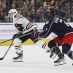 
              Chicago Blackhawks' Tyler Johnson, left, carries the puck across center ice as Columbus Blue Jackets' Sean Kuraly defends during the third period of an NHL hockey game on Saturday, Dec. 31, 2022, in Columbus, Ohio. (AP Photo/Jay LaPrete)
            