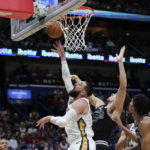 
              New Orleans Pelicans center Jonas Valanciunas (17) goes to the basket against San Antonio Spurs forward Zach Collins in the first half of an NBA basketball game in New Orleans, Thursday, Dec. 22, 2022. (AP Photo/Gerald Herbert)
            