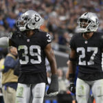 
              Las Vegas Raiders cornerback Nate Hobbs (39) celebrates with cornerback Sam Webb (27) after the Los Angeles Chargers turned the ball over on downs during the second half of an NFL football game, Sunday, Dec. 4, 2022, in Las Vegas. The Raiders won 27-20. (AP Photo/David Becker)
            