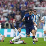 
              Croatia's Mateo Kovacic dribbles past Argentina's Leandro Paredes during the World Cup semifinal soccer match between Argentina and Croatia at the Lusail Stadium in Lusail, Qatar, Tuesday, Dec. 13, 2022. (AP Photo/Natacha Pisarenko)
            