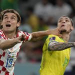 
              Croatia's Borna Sosa, left, fights for the ball with Brazil's Antony during the World Cup quarterfinal soccer match between Croatia and Brazil, at the Education City Stadium in Al Rayyan, Qatar, Friday, Dec. 9, 2022. (AP Photo/Frank Augstein)
            
