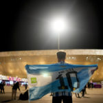
              A man holds an Argentinian flag prior to the World Cup quarterfinal soccer match between the Netherlands and Argentina, outside the Lusail Stadium in Lusail, Qatar, Friday, Dec. 9, 2022. (AP Photo/Natacha Pisarenko)
            