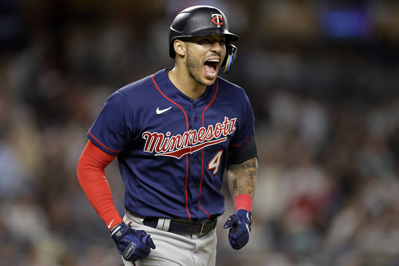 FILE - Minnesota Twins' Carlos Correa reacts after hitting a two-run home run against the New York ...