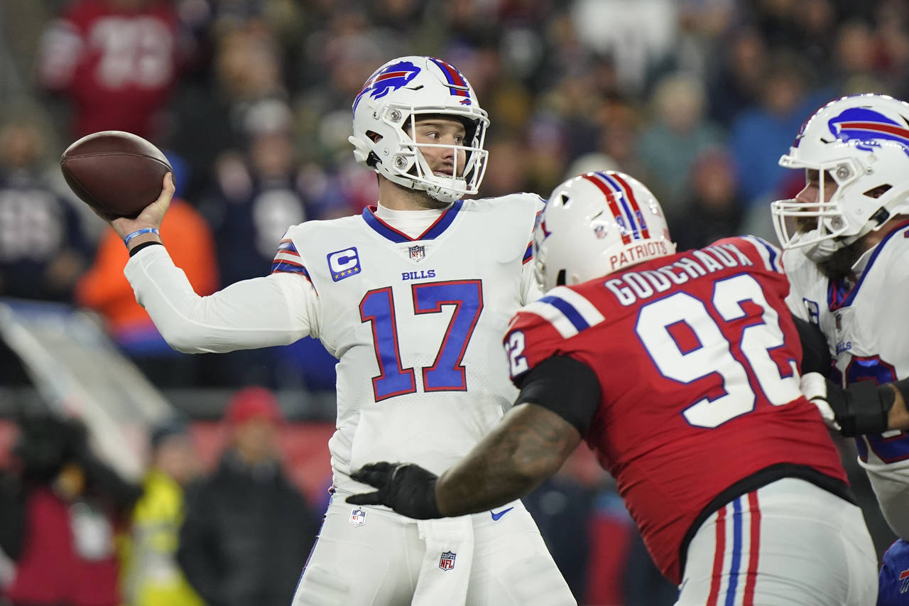Buffalo Bills quarterback Josh Allen (17) throws under pressure from New England Patriots defensive...