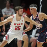 
              Arizona guard Kerr Kriisa (25) defends against Utah guard Rollie Worster (25) during the first half of an NCAA college basketball game Thursday, Dec. 1, 2022, in Salt Lake City. (AP Photo/Rick Bowmer)
            