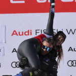 
              The winner Italy's Sofia Goggia celebrates on podium after an alpine ski, women's World Cup downhill race, in St. Moritz, Switzerland, Saturday, Dec. 17, 2022. (AP Photo/Marco Trovati)
            