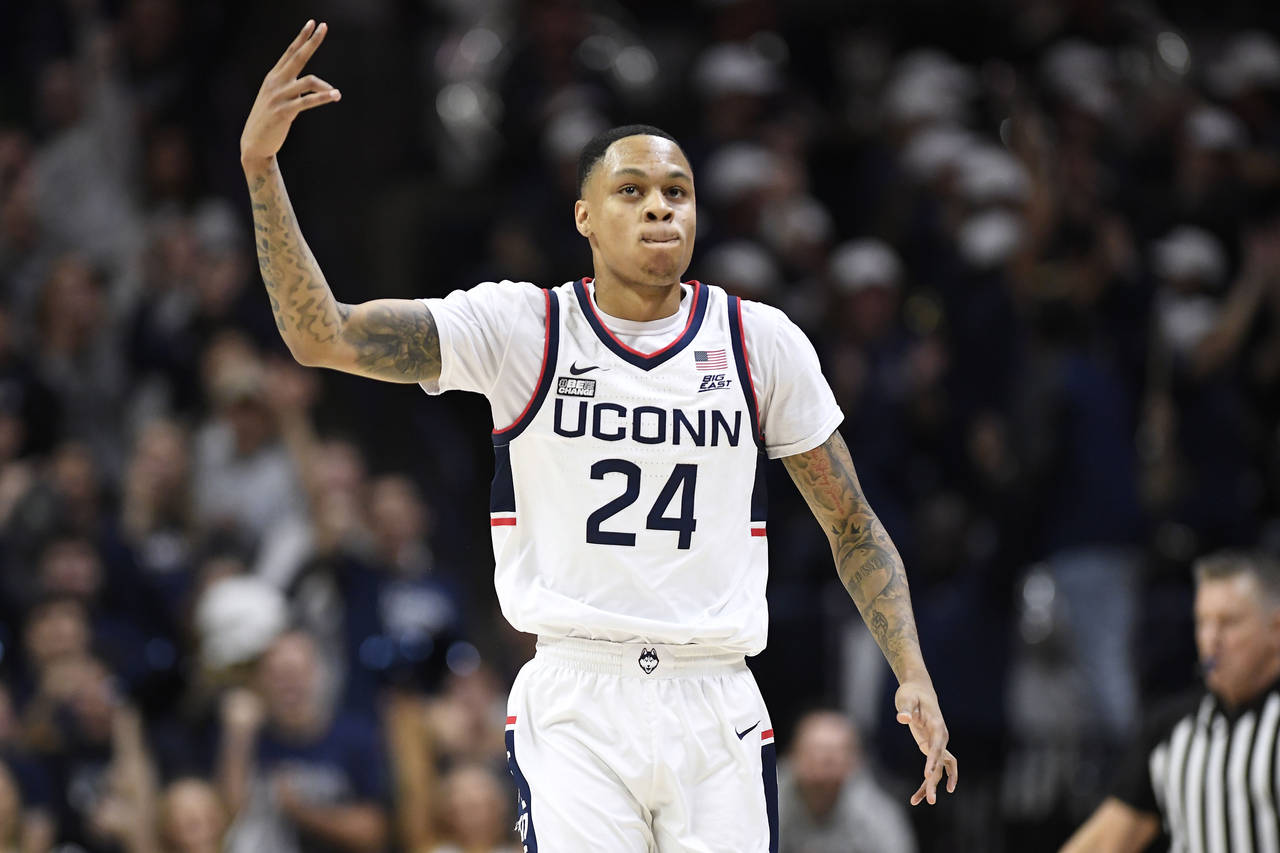 Connecticut's Jordan Hawkins (24) reacts after making a basket in the first half of an NCAA college...