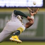 
              Oakland Athletics second baseman Tony Kemp (5) dives to catch a fly ball hit by Los Angeles Angels' Livan Soto during the eighth inning of a baseball game in Anaheim, Calif., Tuesday, Sept. 27, 2022. (AP Photo/Ashley Landis)
            