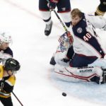 
              Columbus Blue Jackets' Daniil Tarasov (40) loses his mask after blocking a shot in front of Boston Bruins' Trent Frederic (11) during the third period of an NHL hockey game, Saturday, Dec. 17, 2022, in Boston. (AP Photo/Michael Dwyer)
            