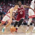 
              Arizona guard Kerr Kriisa (25) drives against Indiana guard Xavier Johnson (0) during the second half of an NCAA college basketball game Saturday, Dec. 10, 2022, in Las Vegas. (AP Photo/Chase Stevens)
            