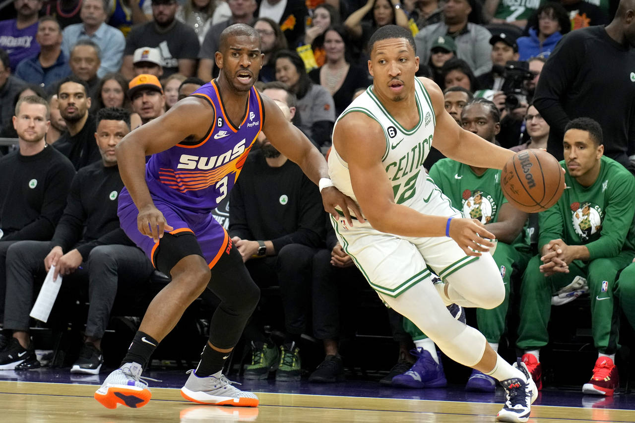 Boston Celtics forward Grant Williams drives past Phoenix Suns guard Chris Paul (3) during the firs...