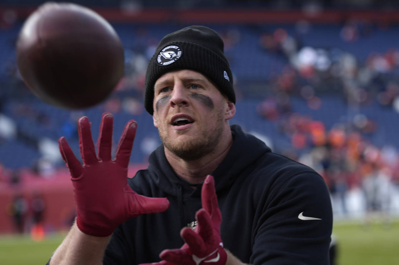 Arizona Cardinals defensive end J.J. Watt plays catch with fans prior to an NFL football game again...
