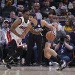 
              Indiana Pacers' Andrew Nembhard (2) is defended by Miami Heat's Kyle Lowry during the first half of an NBA basketball game, Monday, Dec. 12, 2022, in Indianapolis. (AP Photo/Darron Cummings)
            