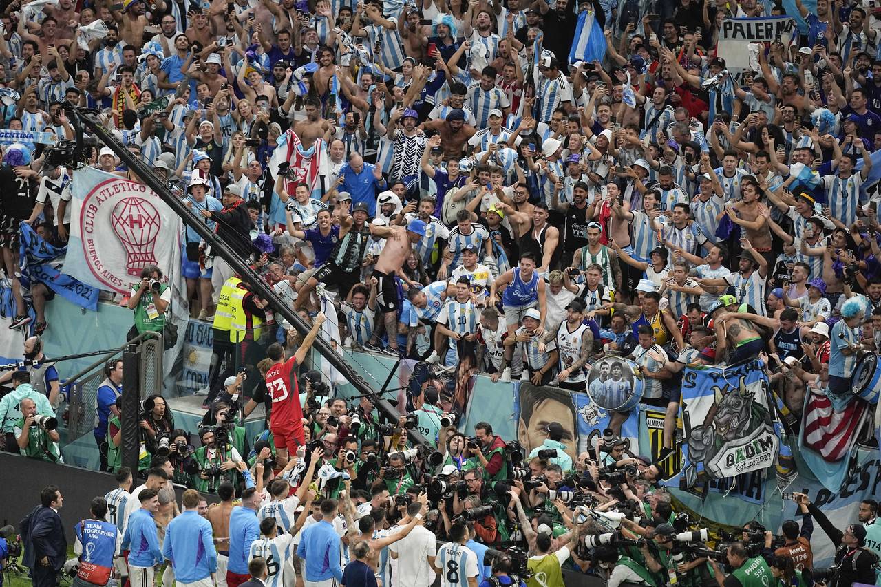 Argentina players celebrate with their fans at the end of the World Cup quarterfinal soccer match b...
