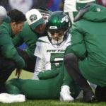 
              New York Jets quarterback Mike White receives assistance following a play in the first half of an NFL football game against the Buffalo Bills, Sunday, Dec. 11, 2022, in Orchard Park, N.Y. (AP Photo/Jeffrey T. Barnes)
            