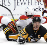 
              New Jersey Devils' Brendan Smith (2) collides with Pittsburgh Penguins' Sidney Crosby (87) during the second period of an NHL hockey game in Pittsburgh, Friday, Dec. 30, 2022. (AP Photo/Gene J. Puskar)
            