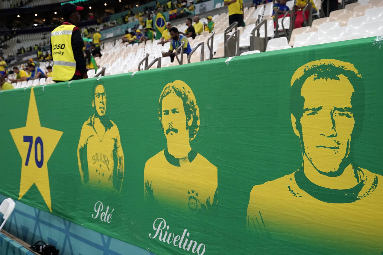 Brazil supporters put up a banner featuring Brazil team legends including Pele prior to the World C...