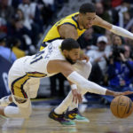 
              New Orleans Pelicans forward Garrett Temple (41) and Indiana Pacers guard Tyrese Haliburton (0) battle for the ball in the first half of an NBA basketball game in New Orleans, Monday, Dec. 26, 2022. (AP Photo/Matthew Hinton)
            