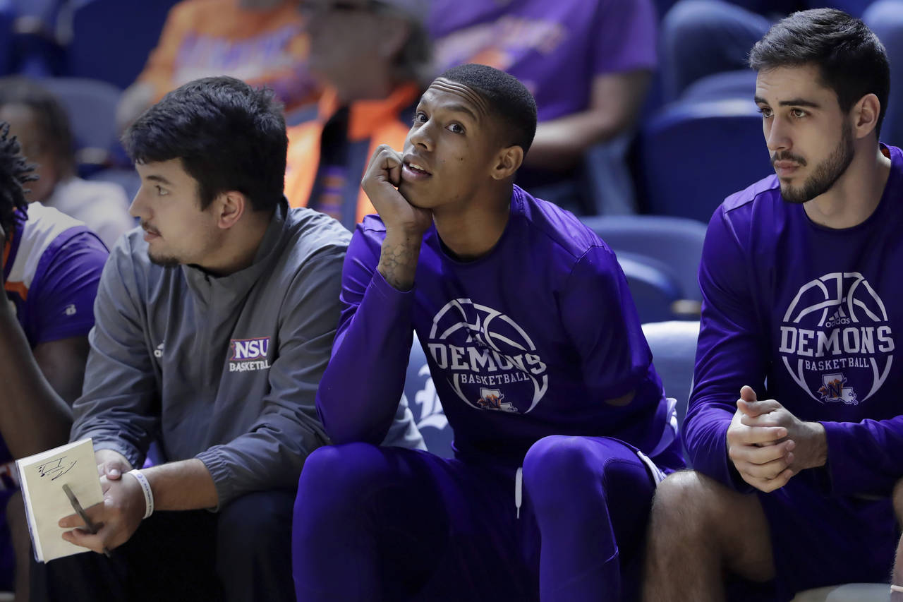 Hansel Enmanuel, center, a freshman guard from the Dominican Republic for Northwestern State, on th...