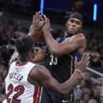 
              Indiana Pacers' Myles Turner (33) goes to the basket against Miami Heat's Jimmy Butler (22) during the second half of an NBA basketball game, Monday, Dec. 12, 2022, in Indianapolis. (AP Photo/Darron Cummings)
            