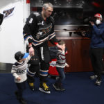 
              Washington Capitals left wing Alex Ovechkin (8) walks with his sons Ilya, left, and Sergei, right, in the locker room after an NHL hockey game against the Winnipeg Jets, Friday, Dec. 23, 2022, in Washington. (AP Photo/Nick Wass)
            