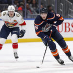 
              New York Islanders defenseman Noah Dobson (8) skates up the ice trailed by Florida Panthers center Anton Lundell (15) during the second period of an NHL hockey game Friday, Dec. 23, 2022, in Elmont, N.Y. (AP Photo/John Munson)
            