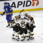 
              Boston Bruins right wing David Pastrnak is congratulated by teammates after scoring during the first period of an NHL hockey game as Buffalo Sabres defenseman Ilya Lyubushkin (46) skates by, Saturday, Dec. 31, 2022, in Boston. (AP Photo/Mary Schwalm)
            