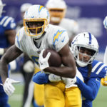 
              Los Angeles Chargers' Mike Williams (81) is tackled by Indianapolis Colts' Stephon Gilmore during the second half of an NFL football game, Monday, Dec. 26, 2022, in Indianapolis. (AP Photo/AJ Mast)
            