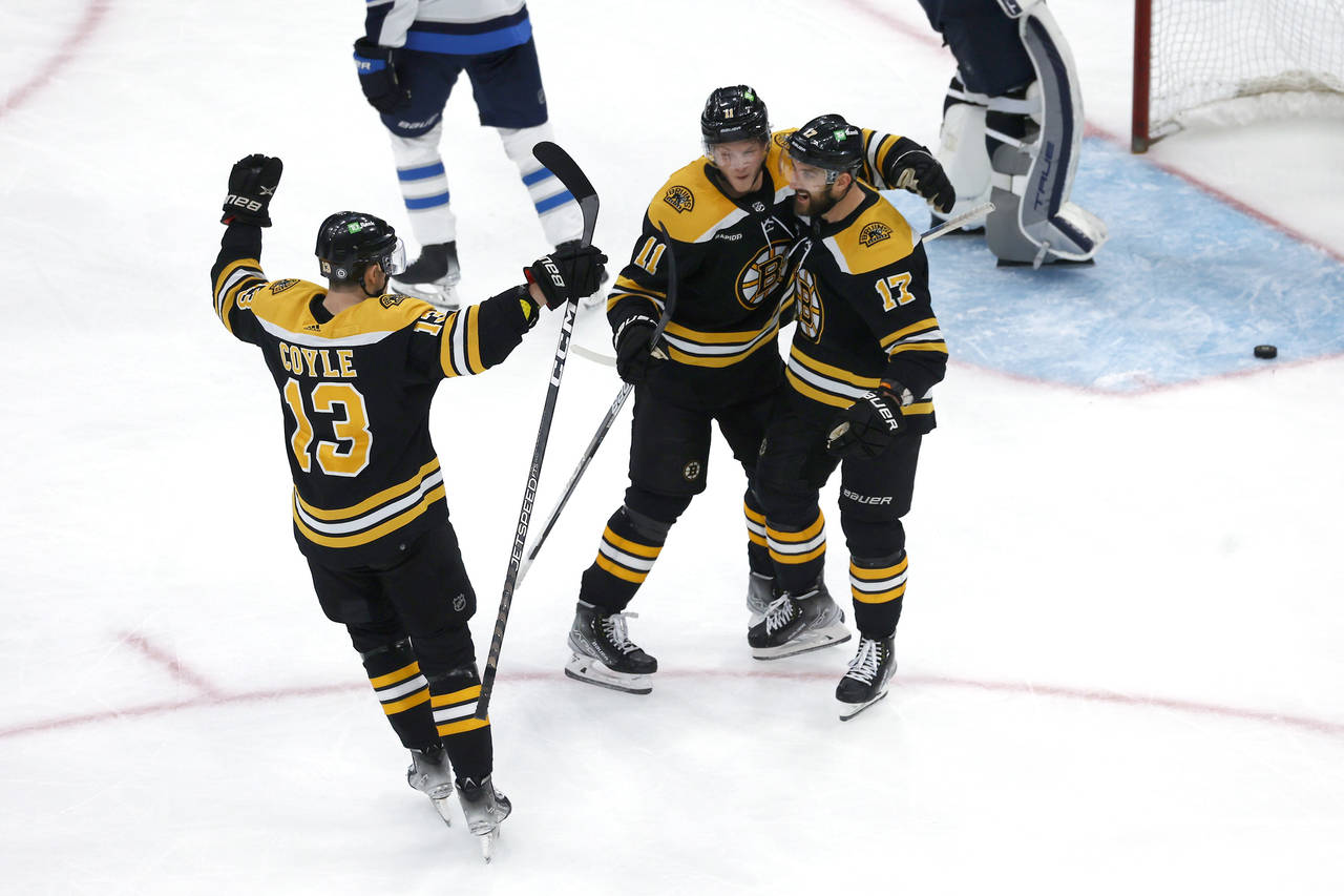 Boston Bruins left wing Nick Foligno (17) is congratulated for his goal against the Winnipeg Jets b...