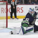 
              Vancouver Canucks goalie Spencer Martin makes a save against the San Jose Sharks during the second period of an NHL hockey game Tuesday, Dec. 27, 2022, in Vancouver, British Columbia. (Darryl Dyck/The Canadian Press via AP)
            