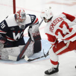 
              Washington Capitals goaltender Charlie Lindgren (79) defends the net against Detroit Red Wings center Michael Rasmussen (27) during the second period of an NHL hockey game, Monday, Dec. 19, 2022, in Washington. (AP Photo/Nick Wass)
            