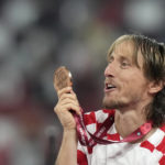 
              Croatia's Luka Modric shows the bronze medal and celebrates at the end of the World Cup third-place playoff soccer match between Croatia and Morocco at Khalifa International Stadium in Doha, Qatar, Saturday, Dec. 17, 2022. (AP Photo/Frank Augstein)
            