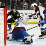 
              Arizona Coyotes left wing Michael Carcone (53) shoots the puck past Colorado Avalanche goaltender Alexandar Georgiev as Avalanche defenseman Samuel Girard, right, watches during the third period of an NHL hockey game in Tempe, Ariz., Tuesday, Dec. 27, 2022. The Coyotes won 6-3. (AP Photo/Ross D. Franklin)
            