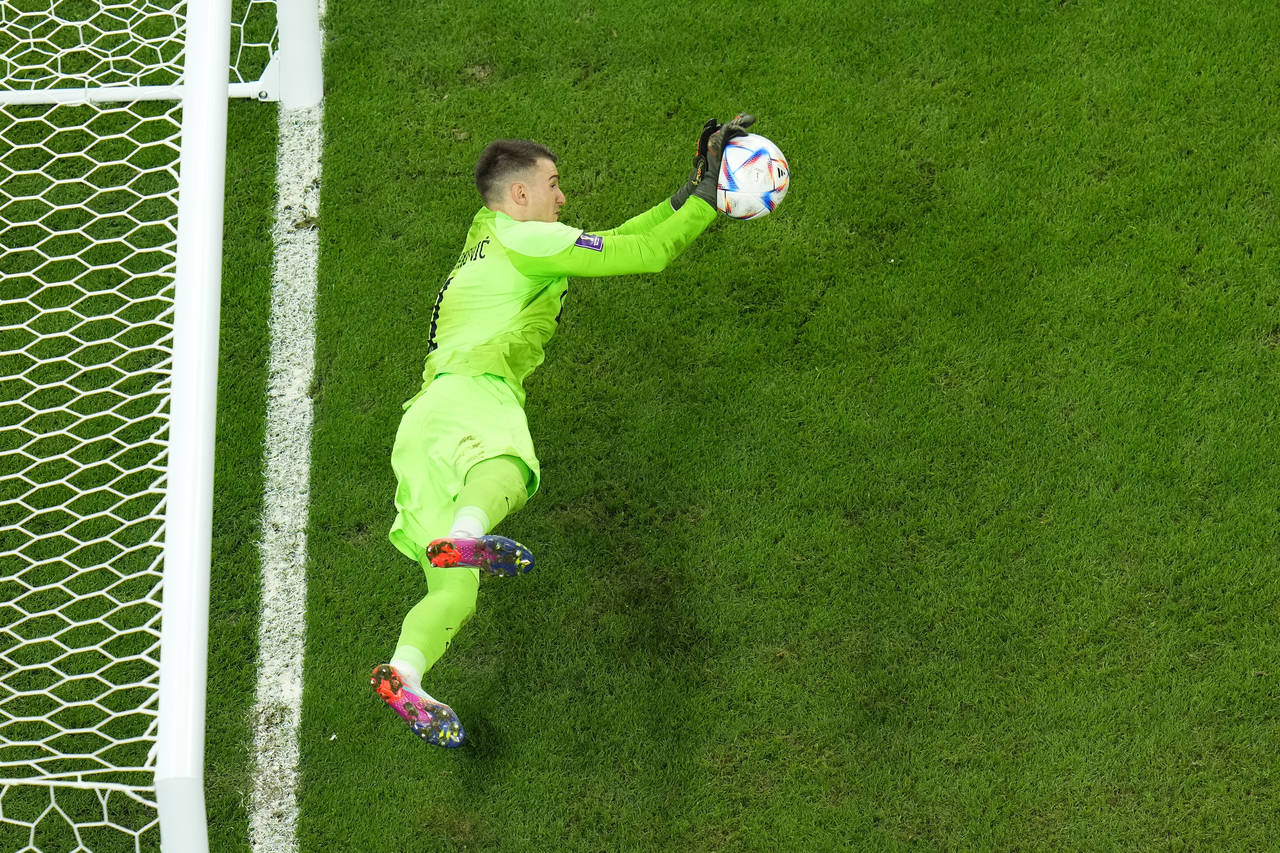 Croatia's goalkeeper Dominik Livakovic saves a shot during a penalty shootout during the World Cup ...
