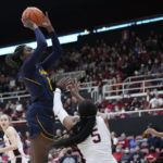 
              California forward Ugonne Onyiah, left, shoots over Stanford forward Francesca Belibi (5) during the first half of an NCAA college basketball game in Stanford, Calif., Friday, Dec. 23, 2022. (AP Photo/Godofredo A. Vásquez)
            