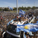 
              The Argentine soccer team that won the World Cup title ride on top of an open bus during their homecoming parade in Buenos Aires, Argentina, Tuesday, Dec. 20, 2022. (AP Photo/Rodrigo Abd)
            