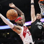 
              Toronto Raptors guard Gary Trent Jr. (33) loses the ball as Los Angeles Clippers center Ivica Zubac (40) defends during the second half of an NBA basketball game Tuesday, Dec. 27, 2022, in Toronto. (Frank Gunn/The Canadian Press via AP)
            